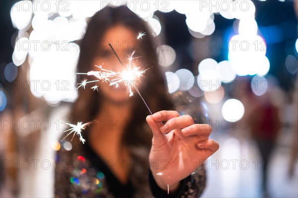 Winter lifestyle at Christmas. Brunette Caucasian girl in a fashionable dress with sequins