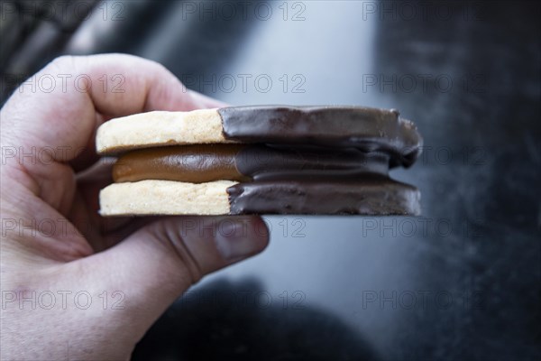 Closeup of a hand holding an argentine alfajor