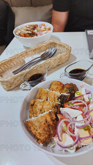 Filipino breakfast of fried bangus or milkfish with tomato and salted duck egg salad from Philippines