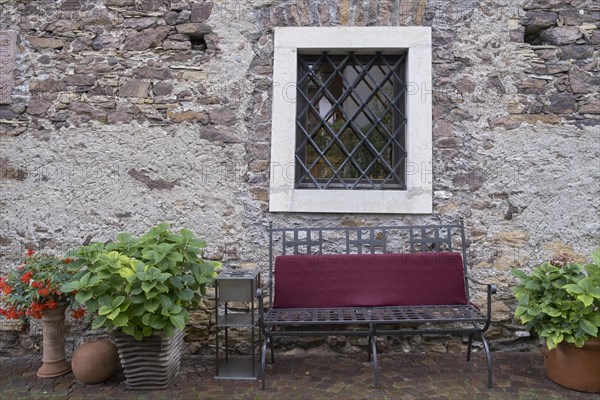 Bench in front of an old house made of quarry stones