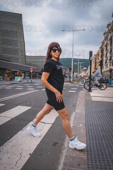 Lifestyle in the city. A young brunette with sunglasses