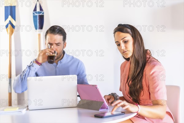 A couple teleworking at home