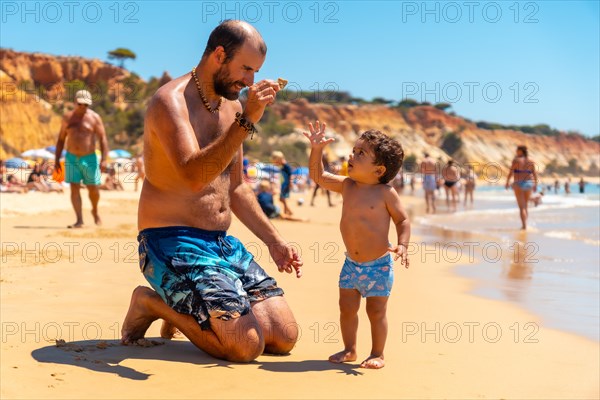 Father playing in the sand