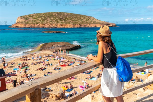 A tourist on Cala Comte beach on the island of Ibiza. Sunset. Balearic