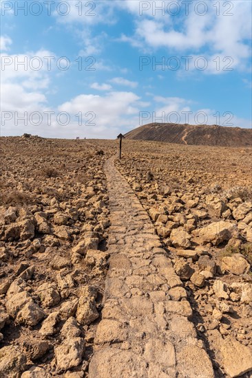 Beautiful stone path to the Crater of the Calderon Hondo volcano near Corralejo