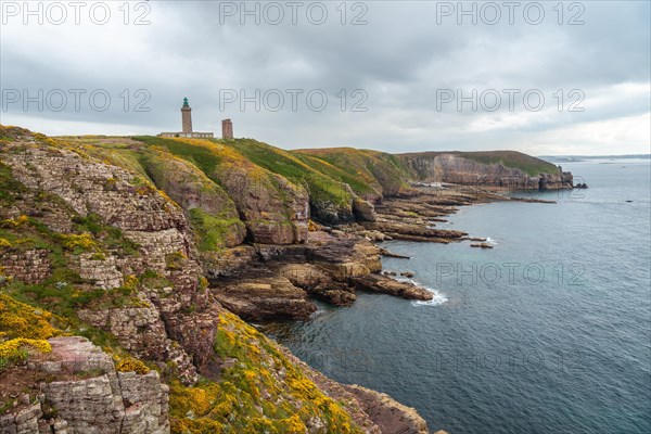 The beautiful coastline next to the Phare Du Cap Frehel is a maritime lighthouse in Cotes-dÂ´Armor France . At the tip of Cap Frehel