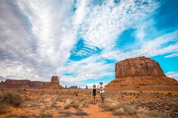 A couple in the Monument Valley National Park in Three Sisters. Utah