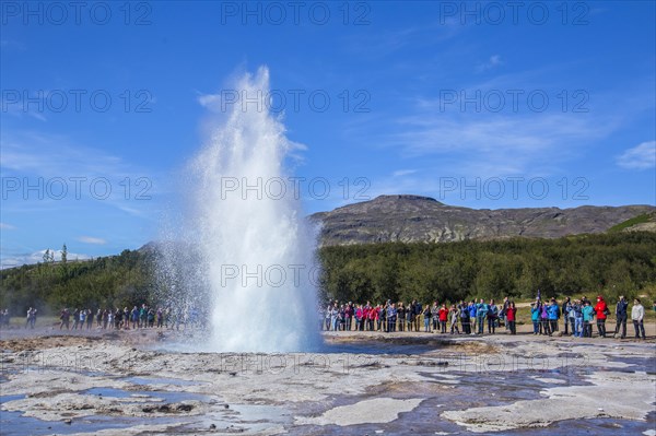 Geysir Strokkur with the sun in the background of the golden circle of the south of Iceland