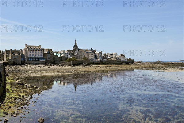 Old town with buildings and church tower by the sea