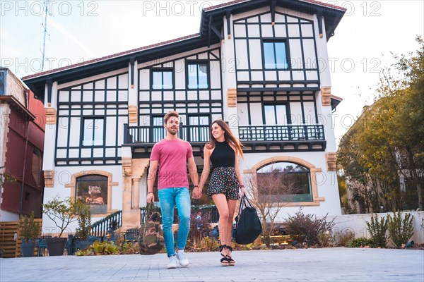 A Caucasian couple leaving the hotel after spending their wonderful vacation. Summer lifestyle