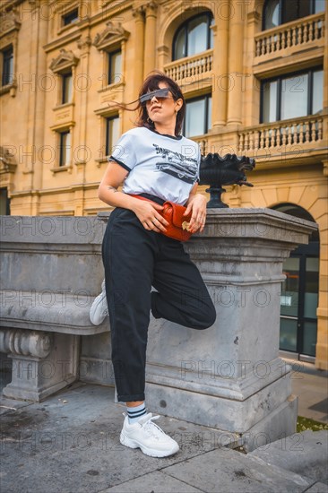 Lifestyle in the city. A young brunette in sunglasses