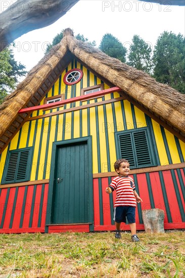 Playing in a traditional Madeiran house like those of Santana in the forest of Caldeirao Verde