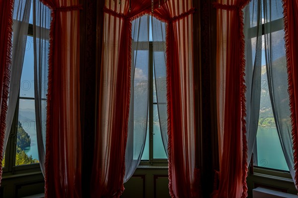 Window View from The Historical Grandhotel Giessbach with View over Mountain and Lake Brienz with Sunlight in Bernese Oberland