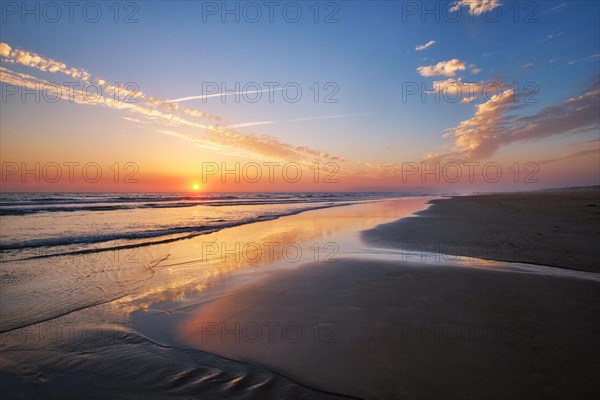 Atlantic ocean sunset with surging waves at Fonte da Telha beach