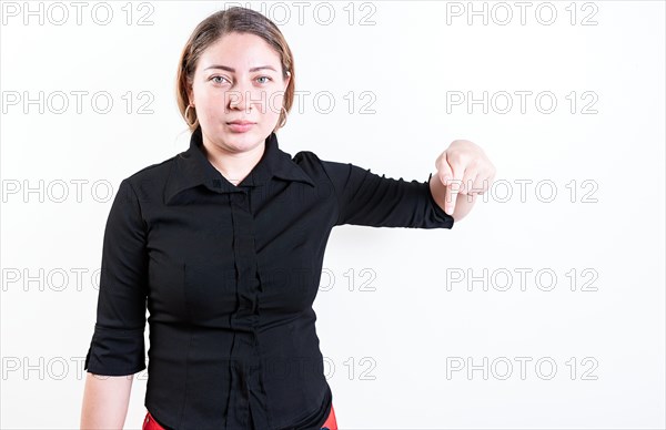 Young woman pointing advertising down. Beautiful latin girl pointing down an advertisement. Latin people pointing down at a banner