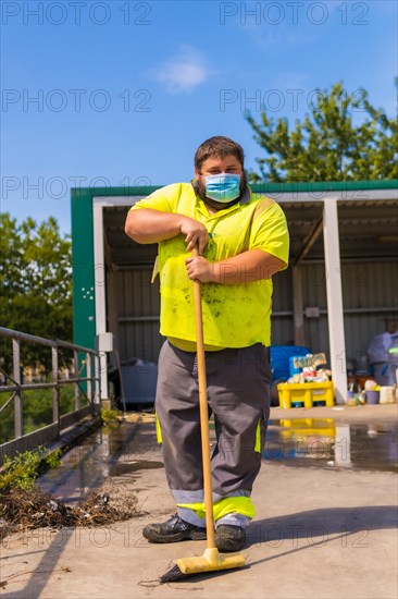 Worker in a recycling factory or clean point and garbage with a face mask and with security protections