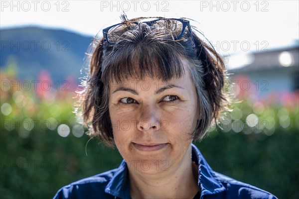 Headshot on a Happy Smiling Woman with Eyeglasses in a Sunny Day in Switzerland