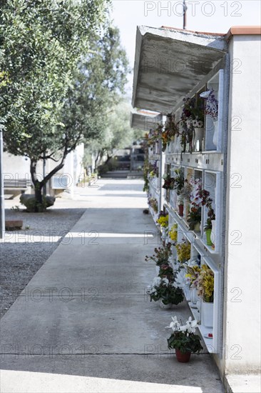 Wall with decorated urns graves in a cemetery in Sardinia