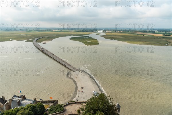 The arrival trail to the famous Mont Saint-Michel Abbey at high tide in the Manche department