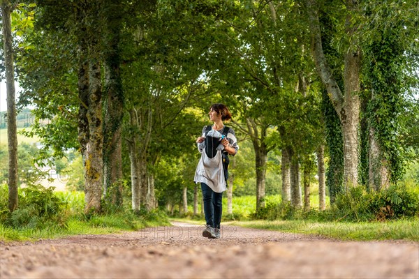 A young mother with her baby in the Broceliande forest