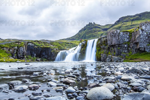 The famous Icelandic mountain Kirkjufell and the small waterfalls