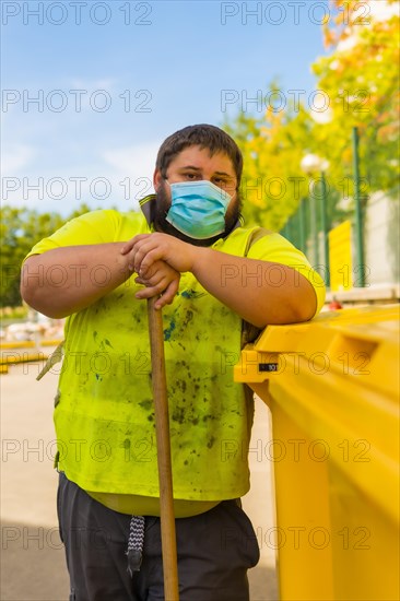 Worker in a recycling factory or clean point and garbage with a face mask and with security protections