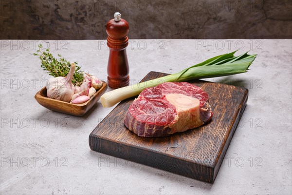 Raw beef shank cross-cut on wooden chopping board