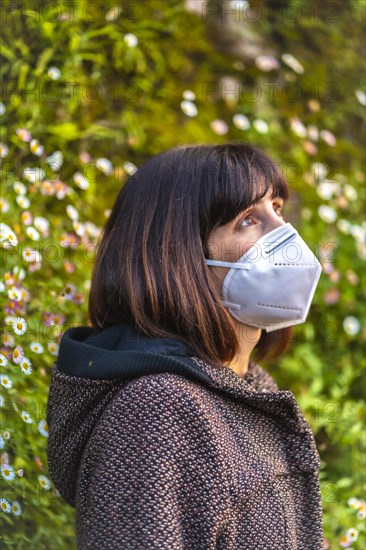 A thoughtful young woman on her first walks in mistrust. First walks of the uncontrolled Covid-19 pandemic