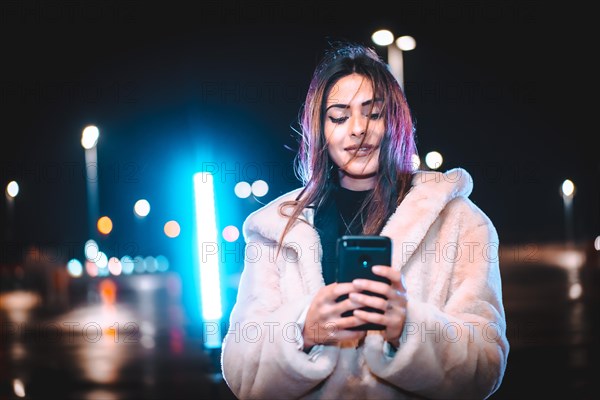 Caucasian brunette writing a message on the phone