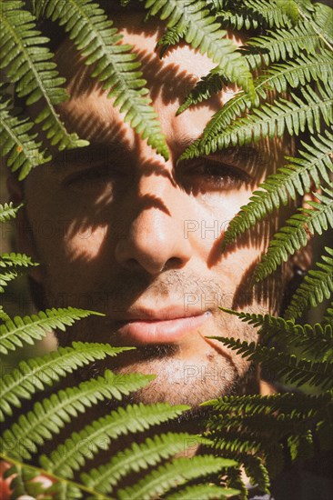 A young boy inside ferns in nature. Listorreta Natural Park in the town of Errenteria in the Penas de Aya or Aiako Harria park. Gipuzkoa