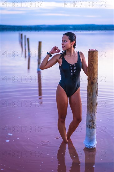 A young brunette Caucasian on vacation in the pink lagoon of Torrevieja