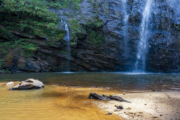 Waterfalls trickling down rocks into a small lake in Minas Gerais