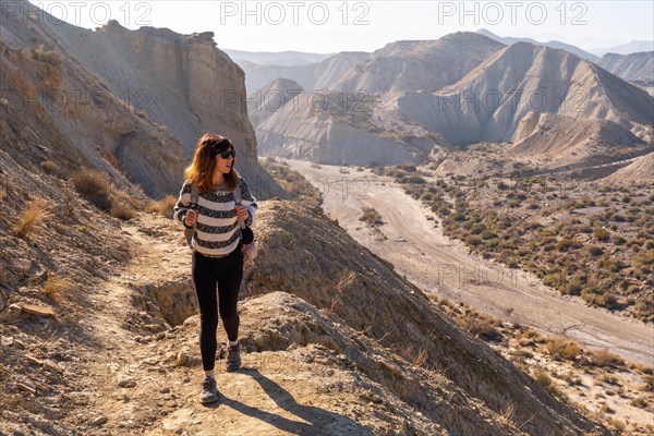 A young hiker girl up in the canyon on Rambla de Lanujar in the Tabernas desert