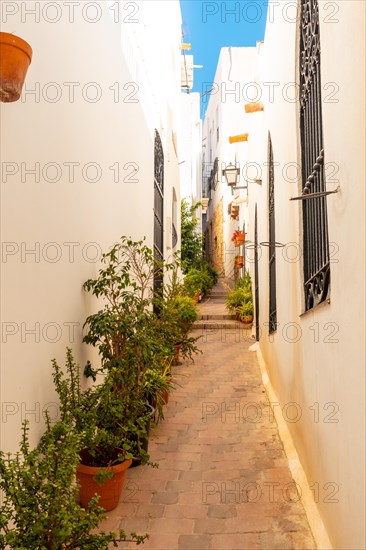 Road between houses in Mojacar with white houses on top of the mountain. Costa Blanca in the Mediterranean Sea
