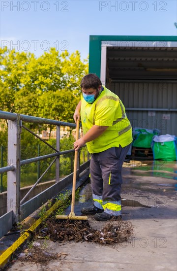 Worker in a recycling factory or clean point and garbage with a face mask and with security protections