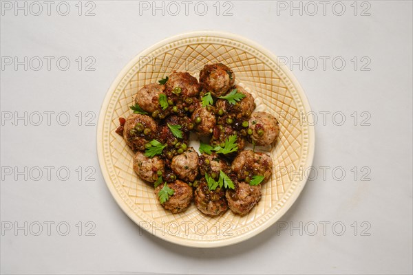 Plate with minced meat meatballs with green pea and cranberry jam