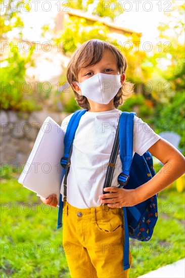 Caucasian child with face mask ready for back to school. New normality