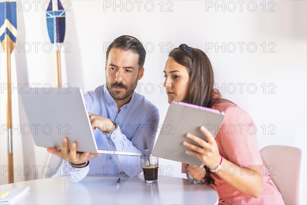 A couple teleworking at home