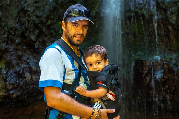 A father with his son on the waterfall trek at Levada do Caldeirao Verde