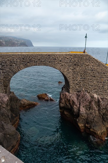 Coast of Ponta do Sol in summer and a marine promenade called Cais da