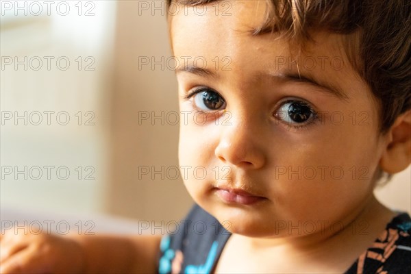Portrait of a one year old Caucasian boy looking at the camera