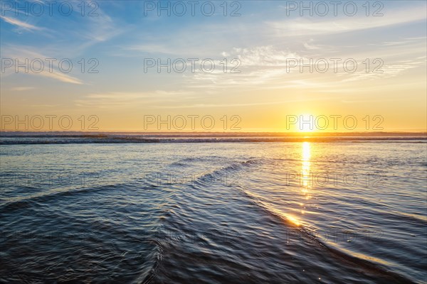 Atlantic ocean sunset with surging waves at Fonte da Telha beach