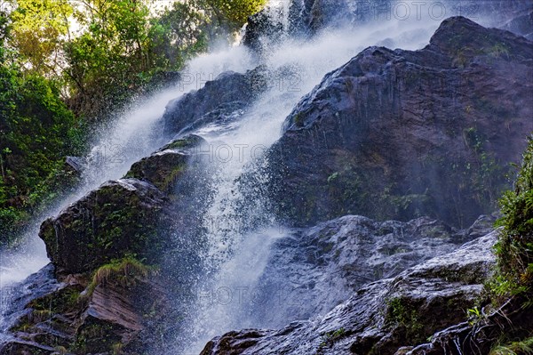 Water running through the rocks and forest forming a beautiful waterfall in Minas Gerais