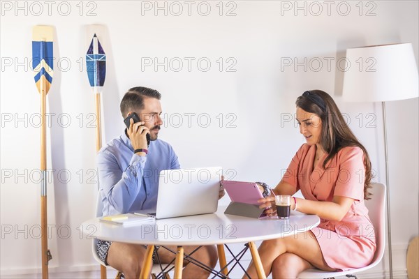 A couple teleworking at home