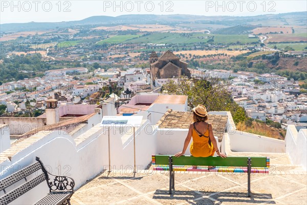 A tourist sitting looking at the tourist town of Arcos de la Frontera in Cadiz