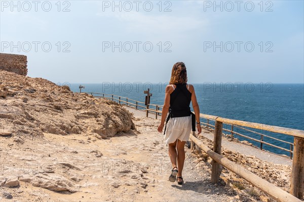 A young tourist walking on the path in the Cuevas de Ajuy