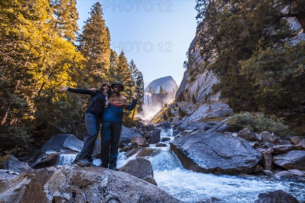 A couple in Vernal Falls waterfall of Yosemite National Park