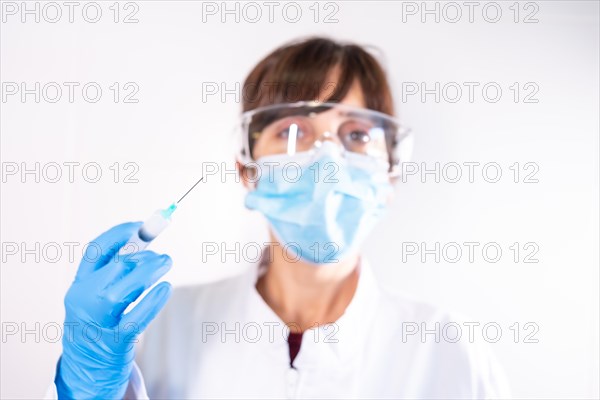 Female doctor with transparent glasses face mask with coronavirus vaccine