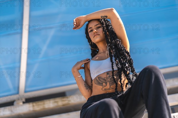 Young black woman with long braids and tattoos