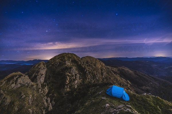 A tent under the stars on Mount Penas de Aya in Oiartzun. Basque Country